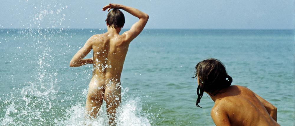 Ein junges Paar badet am FKK-Strand in Prerow.