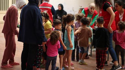 A Save The Children NGO’s staff plays with children in a school hosting displaced families, in Chouf area, Lebanon October 15, 2024. REUTERS/Louisa Gouliamaki