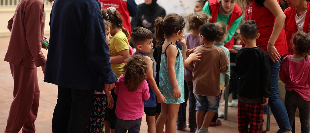 A Save The Children NGO’s staff plays with children in a school hosting displaced families, in Chouf area, Lebanon October 15, 2024. REUTERS/Louisa Gouliamaki
