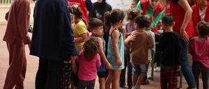 A Save The Children NGO’s staff plays with children in a school hosting displaced families, in Chouf area, Lebanon October 15, 2024. REUTERS/Louisa Gouliamaki