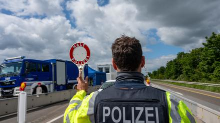 Rheinland-Pfalz, Trier: Ein Bundespolizist hält auf der A64 mit einer Kelle ein Fahrzeug an.
