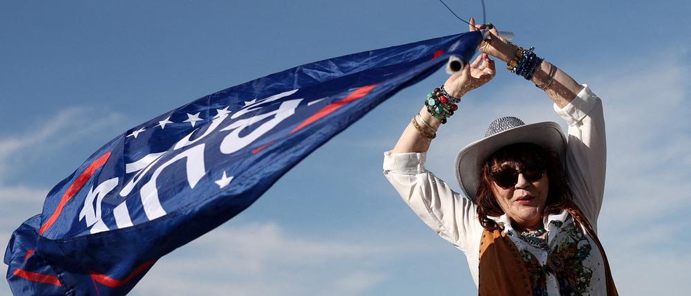 Ein Unterstützer hält eine Trump-Flagge vor einer Wahlkampfveranstaltung des republikanischen Präsidentschaftskandidaten