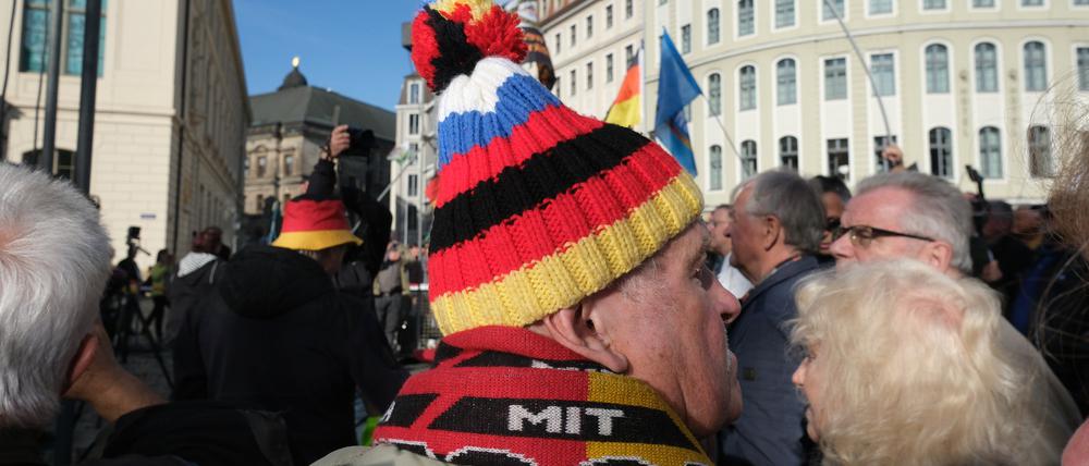 Auf einer Pegida-Demonstration in Dresden. Ein Teilnehmer mit Mütze in den deutschen und russischen Nationalfarben. 