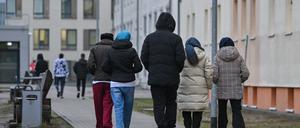 Migranten gehen über das Gelände der Zentralen Erstaufnahmeeinrichtung für Asylbewerber (ZABH) des Landes Brandenburg in Eisenhüttenstadt.