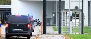 Mit eingeschaltetem Blaulicht fahren mehrere Wagen auf den Hof an der Außenstelle des Bundesgerichtshofs. 