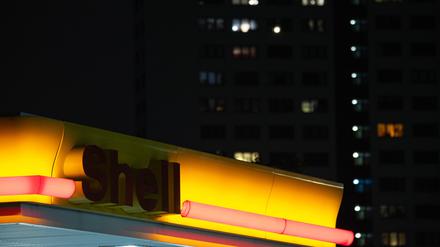 Blick auf einen nicht erleuchteten Shell-Schriftzug einer Tankstelle im Dunkeln in Berlin. Umweltorganisationen hatten den Energiekonzern Shell wegen des Ausstoßes von CO₂ verklagt. In erster Instanz verpflichtete das Gericht den Konzern, den CO₂-Ausstoß bis 2030 um 45 Prozent zu reduzieren. 