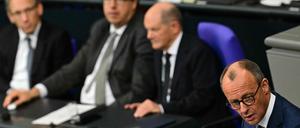 Opposition leader Friedrich Merz (R), also head of Germany's conservative Christian Democratic Union (CDU) party, gives a speech during a session on November 13, 2024 at the Bundestag (lower house of parliament) in Berlin, following the breakdown of Scholz' three-party coalition. Germany is headed for snap elections on February 23, the main parties agreed on November 12, aiming to form a stable government after Chancellor Olaf Scholz's three-party coalition collapsed on November 6, 2024. The agreement seeks to quickly restore political stability at a time when Europe's biggest economy is set to shrink for a second year in a row and amid heightened geopolitical volatility, with wars raging in Ukraine and the Middle East and president-elect Donald Trump readying to take power in the US in January 2025. (Photo by Tobias SCHWARZ / AFP)