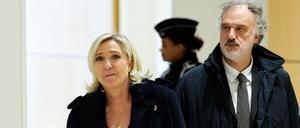 French far-right Rassemblement National (RN) Member of Parliament Marine Le Pen (L) walks with lawyer Rodolphe Bosselut (R) outside the courtroom during a break in the closing arguments hearing of her trial with 24 others for embezzling funds from the European Parliament for the benefit of the far-right party, in Paris on November 13, 2024. (Photo by GEOFFROY VAN DER HASSELT / AFP)