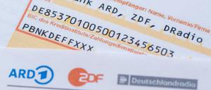 Ein Anschreiben zur Anmeldung für die Rundfunkgebühren liegt auf einem Überweisungsträger. 