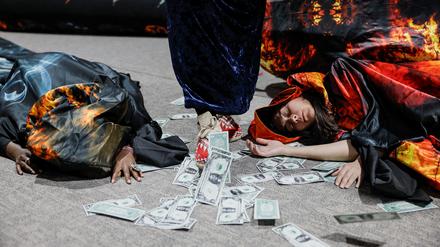 Activists lie next to fake currency bills as they participate in a protest action during the United Nations climate change conference COP29 in Baku, Azerbaijan November 20, 2024. REUTERS/Maxim Shemetov