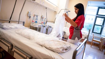 Teyssir Ben Rejeb, Pflegerin, bereitet im Vivantes Auguste-Viktoria-Klinikum ein Bett für den nächsten Patienten vor. 
