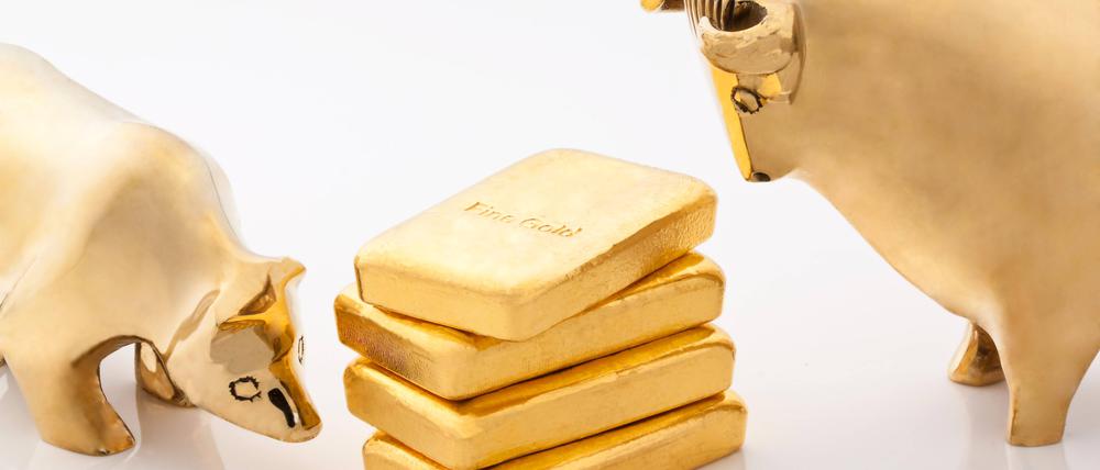 Goldener Bulle und Bär, in der Mitte kleine Goldbarren.