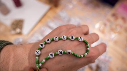 Delegierte basteln Armbänder mit dem Schriftzug «Kanzler Era» bei der Bundesdelegiertenkonferenz der Grünen.