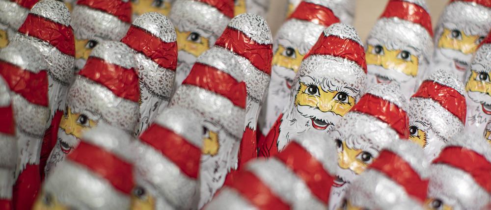 Schoko-Weihnachtsmänner stehen in einem Supermarkt.