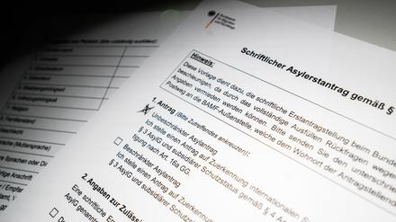 Ein schriftlicher Asylerstantrag des Bundesamts für Migration und Flüchtlinge (BAMF) liegt auf einem Tisch (gestellte Szene). 