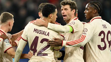 Bayern Munich's German midfielder #42 Jamal Musiala is congratulated after scoring his team's fourth goal during the UEFA Champions League football match between FC Shakhtar Donetsk and FC Bayern Munich in Gelsenkirchen, western Germany on December 10, 2024. (Photo by INA FASSBENDER / AFP)