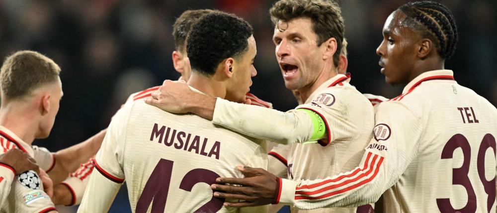 Bayern Munich's German midfielder #42 Jamal Musiala is congratulated after scoring his team's fourth goal during the UEFA Champions League football match between FC Shakhtar Donetsk and FC Bayern Munich in Gelsenkirchen, western Germany on December 10, 2024. (Photo by INA FASSBENDER / AFP)