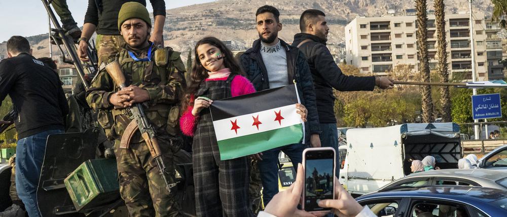 Vom Diktator befreit. Soldaten und Zivilisten mit der Flagge der syrischen Regimegegner.
