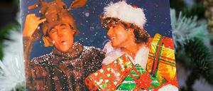 Close up of vintage vinyl record cover single with famous Wham last christmas song in decorated fir tree, Viersen, Germany - December 9. 2020: Close up of vintage vinyl record cover single with famous Wham last christmas song in decorated fir tree