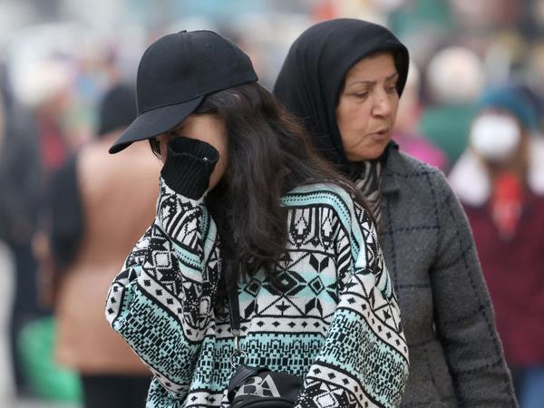An Iranian woman, not wearing the mandatory hijab, walks in a street in the capital Tehran on December 12, 2024. Iranian President Masoud Pezeshkian has expressed doubts about new legislation imposing tougher penalties on women who flout mandatory hijab regulations. Parliament has approved the new "hijab and chastity" law, but it requires the president's signature on December 13 to take effect. (Photo by AFP)