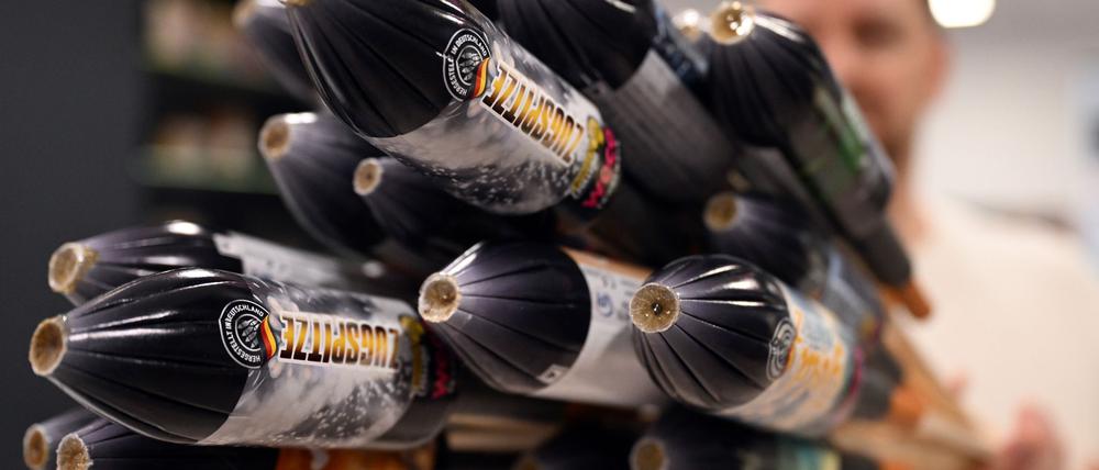 Ein Mitarbeiter hält im Showroom der Feuerwerksfirma Weco Silvesterraketen. 