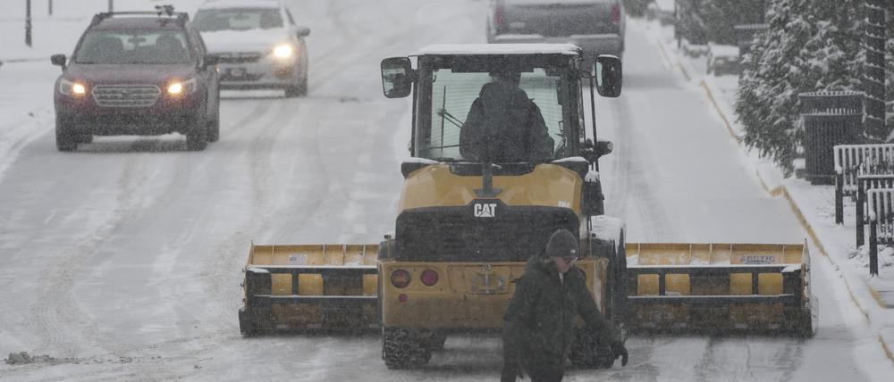 Ein Schneepflug räumt einen Parkplatz während des schweren Wintersturms in den USA..