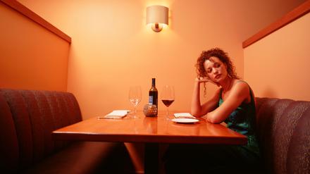 Frau wartet auf ihr Date in einer Bar.