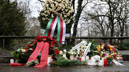 Menschen haben Blumen niedergelegt.