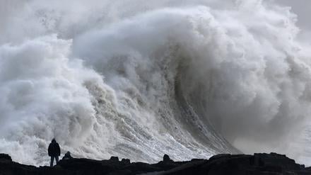 Menschen beobachten große Wellen, als der Sturm Éowyn in Porthcawl, Wales, Großbritannien, ankommt.