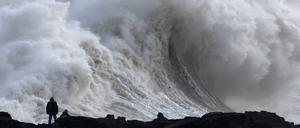 Menschen beobachten große Wellen, als der Sturm Éowyn in Porthcawl, Wales, Großbritannien, ankommt.
