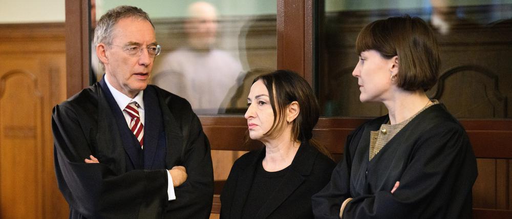 Dilek Kalayci (M, SPD) unterhält sich mit ihren Rechtsanwälten, Robert Unger und Sophia Zabel, vor Prozessbeginn im Gerichtssaal am Kriminalgericht Moabit.