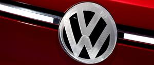 VW-Logo an rotem Auto. Die vom US-Präsidenten angekündigten Zölle auf Autoimporte setzen den VW-Konzern und seine Töchter Audi und Porsche unter Zugzwang.
