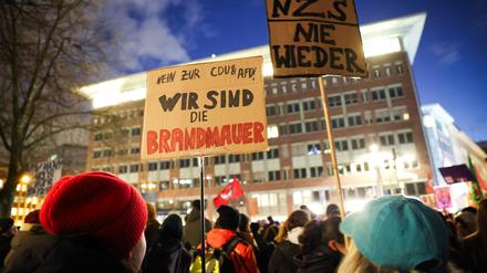 Teilnehmende einer Protestaktion demonstrieren.
