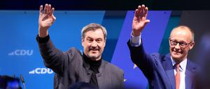 Unions-Kanzlerkandidat Friedrich Merz (r)und CSU-Chef Markus Söder stehen beim Weißwurstessen in der Schützenhalle nach ihren Reden gemeinsam auf der Bühne.