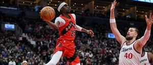 Feb 2, 2025; Toronto, Ontario, CAN;  Toronto Raptors forward Chris Boucher (25) passes the ball over Los Angeles Clippers center Ivica Zubac (40) in the first half at Scotiabank Arena. 
