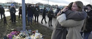 In der Nähe des Tatorts gedenken Menschen mit Blumen und Kerzen der Todesopfer in Örebro.
