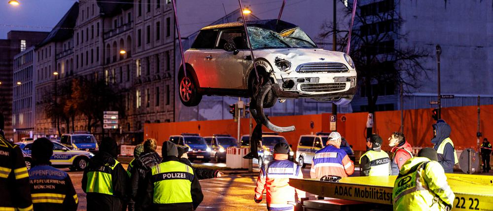 Ein Auto wird am Einsatzort auf einen Abschleppwagen gehoben. In der Münchner Innenstadt ist das Fahrzeug in eine Menschengruppe gefahren.