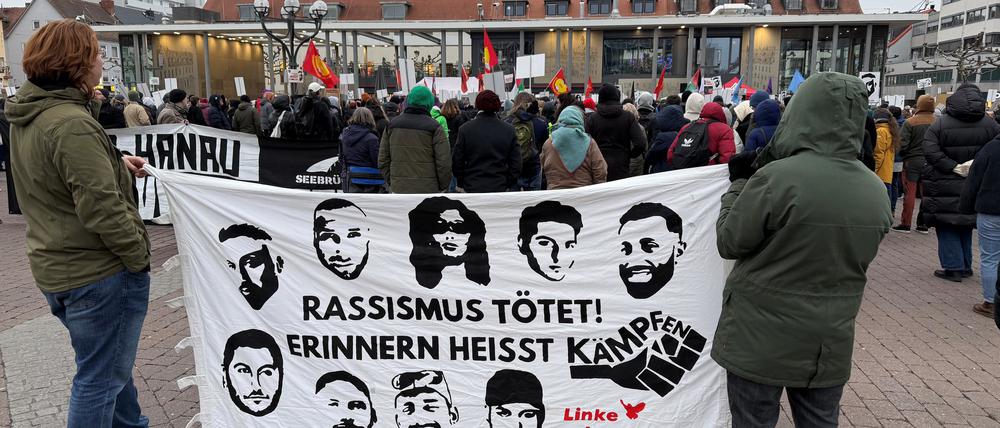 Demonstranten zeigen bei einer Kundgebung auf dem Hanauer Marktplatz ein Transparent mit den Porträts der neun Menschen, die bei dem rassistischen Anschlag am 19.2.2020 ermordet wurden.
