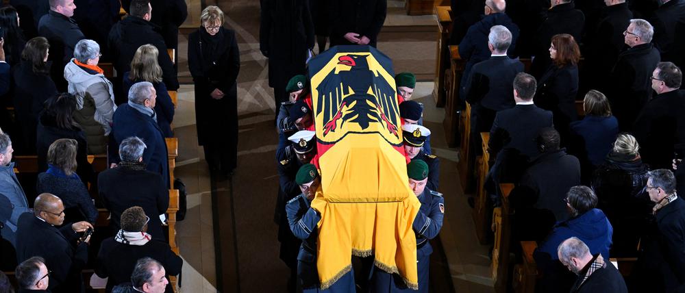 Der mit der deutschen Fahne bedeckte Sarg des verstorbenen ehemaligen Bundespräsidenten Horst Köhler wird beim großen militärischen Ehrengeleit nach dem Trauergottesdienst und Staatsakt von Soldaten aus dem Berliner Dom getragen. Hinter dem Sarg gehen Eva-Luise Köhler, die Witwe, und Bundespräsident Frank-Walter Steinmeier.