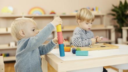 A kindergartener learning colors and shapes with montessori toy.