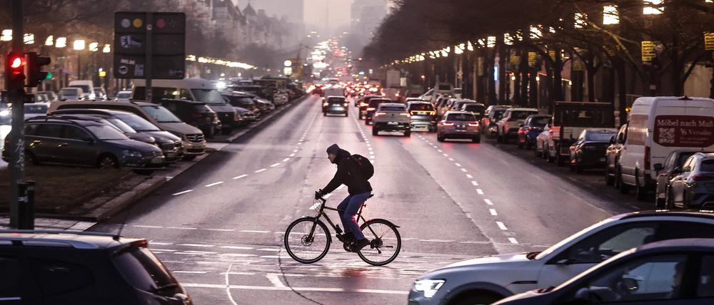 Ein Fahrradfahrer überquert den Kaiserdamm in Berlin-Charlottenburg zum morgendlichen Berufsverkehr.