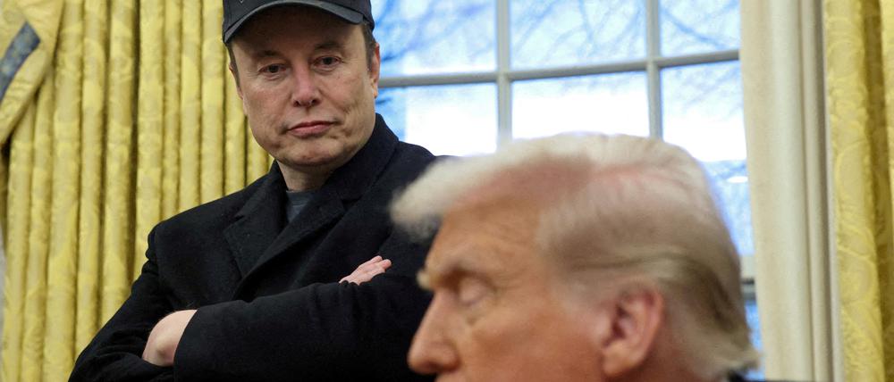 Elon Musk listens to U.S. President Donald Trump speak in the Oval Office of the White House in Washington.