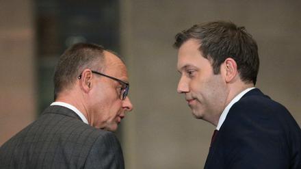 Leader of Germany's Christian Democratic Union (CDU) Friedrich Merz (L) and Germany's Social Democratic Party (SPD) Chairman Lars Klingbeil look at each other as they hold a press conference on planned major investments, in Berlin, on March 4, 2025. Germany's likely next chancellor Friedrich Merz said on March 4, 2025 his centre-right CDU/CSU and the centre-left Social Democrats (SPD) would propose hundreds of billions in extra spending on defence and the economy. (Photo by RALF HIRSCHBERGER / AFP)