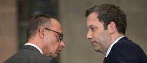 Leader of Germany's Christian Democratic Union (CDU) Friedrich Merz (L) and Germany's Social Democratic Party (SPD) Chairman Lars Klingbeil look at each other as they hold a press conference on planned major investments, in Berlin, on March 4, 2025. Germany's likely next chancellor Friedrich Merz said on March 4, 2025 his centre-right CDU/CSU and the centre-left Social Democrats (SPD) would propose hundreds of billions in extra spending on defence and the economy. (Photo by RALF HIRSCHBERGER / AFP)