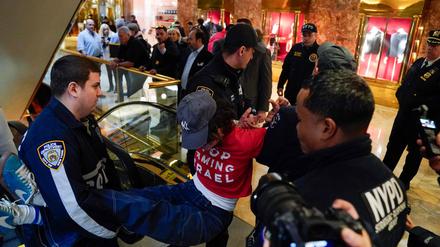 A demonstrators from the human rights organization Jewish Voice for Peace is detained by NYPD officers as they hold a civil disobedience action inside Trump Tower in New York on March 13, 2025. (Photo by TIMOTHY A. CLARY / AFP)