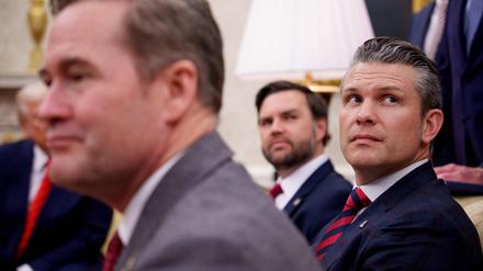 US National Security Adviser Michael Waltz (L), US Vice President J.D. Vance (rear), and Defense Secretary Pete Hegseth (R, listen to a question from a reporter during a meeting in the Oval Office of the White House, Washington, DC, on March 13, 2025. A US journalist was inadvertently included in a group chat in which Defense Secretary Pete Hegseth, Vice President JD Vance and other top officials discussed upcoming strikes against Yemen's Huthi rebels, the White House confirmed on March 24, 2025. (Photo by Andrew Harnik / GETTY IMAGES NORTH AMERICA / AFP)