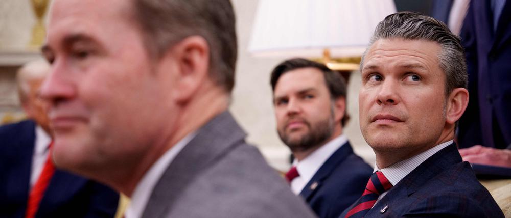US National Security Adviser Michael Waltz (L), US Vice President J.D. Vance (rear), and Defense Secretary Pete Hegseth (R, listen to a question from a reporter during a meeting in the Oval Office of the White House, Washington, DC, on March 13, 2025. A US journalist was inadvertently included in a group chat in which Defense Secretary Pete Hegseth, Vice President JD Vance and other top officials discussed upcoming strikes against Yemen's Huthi rebels, the White House confirmed on March 24, 2025. (Photo by Andrew Harnik / GETTY IMAGES NORTH AMERICA / AFP)