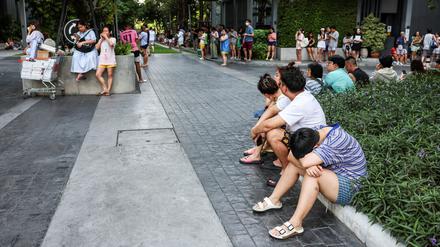 Menschen versammeln sich vor einem Gebäude in Bangkok (Symbolbild).