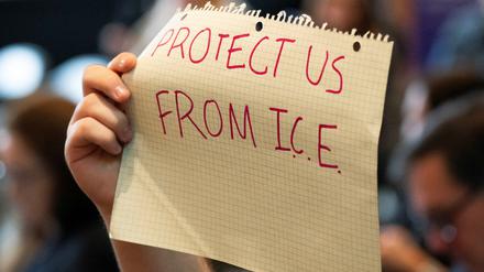 A demonstrator holds a sign calling for protection from U.S. Immigration and Customs Enforcement during a Board of Regents meeting at the University of Washington in Seattle, Washington, U.S., March 12, 2025.  REUTERS/David Ryder