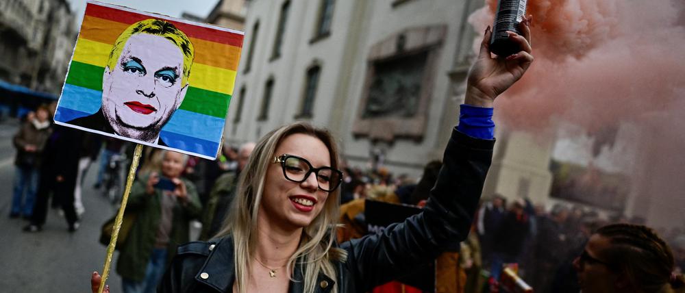 Eine Demonstrantin hält ein Plakat mit dem Bild des ungarischen Ministerpräsidenten Viktor Orbán 